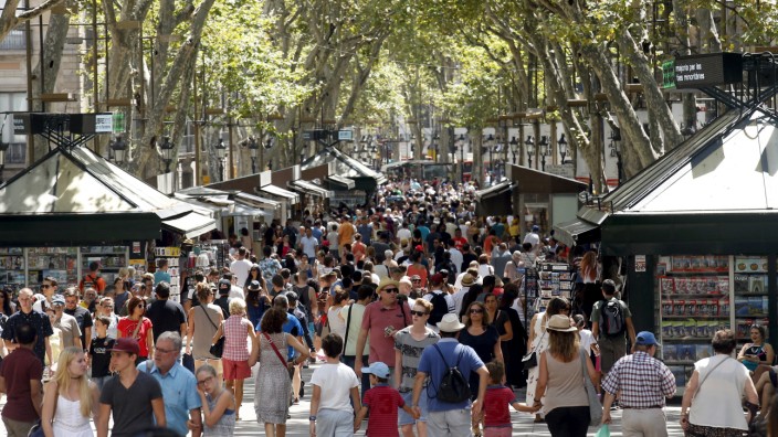 FILE PHOTO: People walk by Las Ramblas in Barcelona
