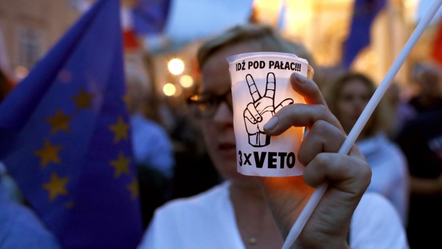 People gather in front of the Supreme Court during a protest against the Supreme Court legislation in Warsaw