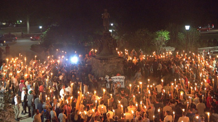White nationalists carry torches on the grounds of the University of Virginia, on the eve of a planned Unite The Right rally in Charlottesville