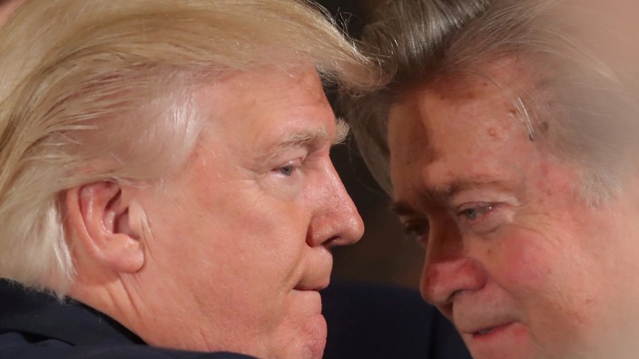 FILE PHOTO: U.S. President Donald Trump talks to chief strategist Steve Bannon during a swearing in ceremony for senior staff at the White House in Washington