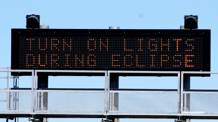A sign on the highway refers to the upcoming solar eclipse near Guernsey