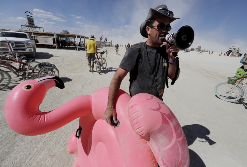 Burning Man participant Cunningham gives running commentary with megaphone as approximately 70,000 people from all over the world gather for Burning Man in the Black Rock Desert of Nevada