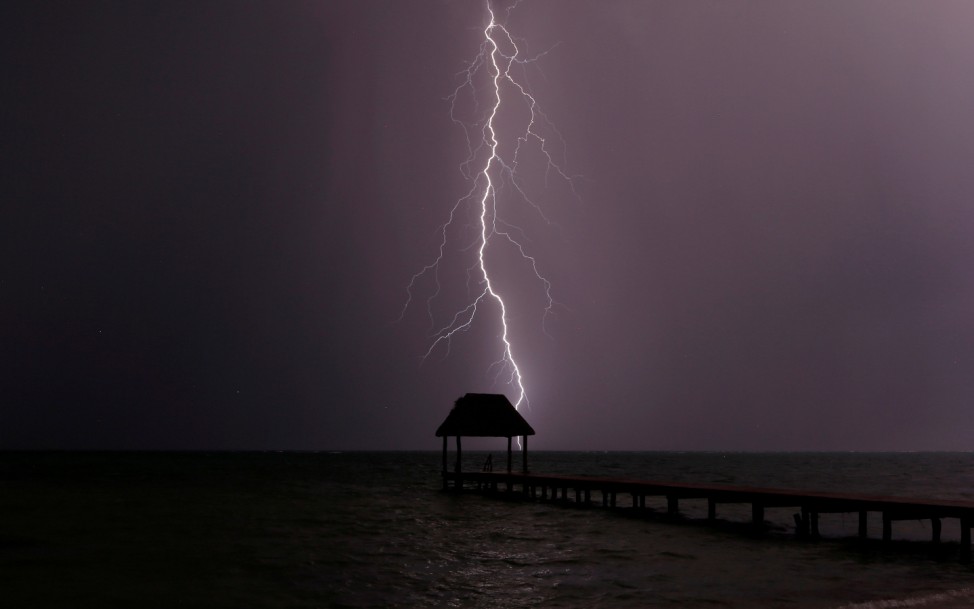 Lightning strikes the Caribbean as a thunderstorm passes Tankah Bay, near Tulum, southern Mexico