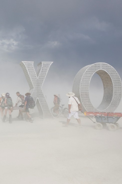 Participants make their way past an art installation as approximately 70,000 people from all over the world gathered for the annual Burning Man arts and music festival in the Black Rock Desert of Nevada