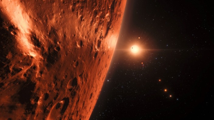 Astronomie: Künstlerische Darstellung eines Planeten im Sternsystem Trappist-1. Auf einigen der dortigen Himmelskörper könnte es flüssiges Wasser geben.