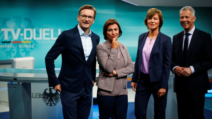 TV presenters pose at the Adlershof TV studio to present the only TV debate of the German election between incumbent German Chancellor Angela Merkel and SPD candidate Martin Schulz