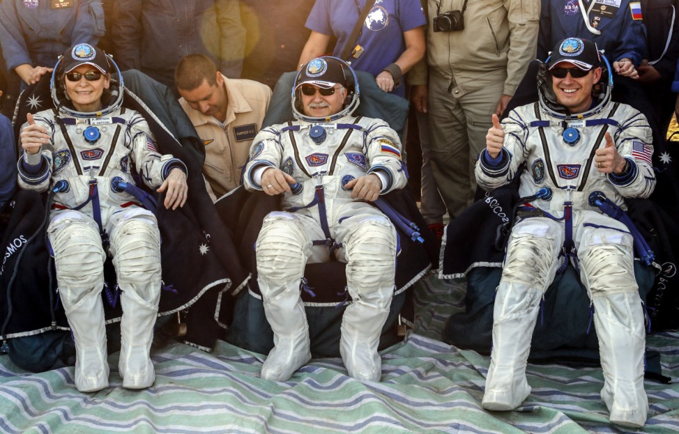 Members of the ISS crew Peggy Annette Whitson of the U.S., Fyodor Yurchikhin of Russia, and Jack Fischer of the U.S. rest shortly after the landing of the Soyuz MS-04 capsule in a remote area outside the town of Dzhezkazgan