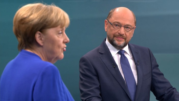 A screen that shows the TV debate between German Chancellor Angela Merkel of the Christian Democratic Union (CDU) and her challenger Germany's Social Democratic Party SPD candidate for chancellor Martin Schulz in Berlin