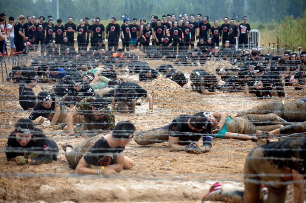 Participants take part in the Spartan Race, an obstacle course race, in Qingdao