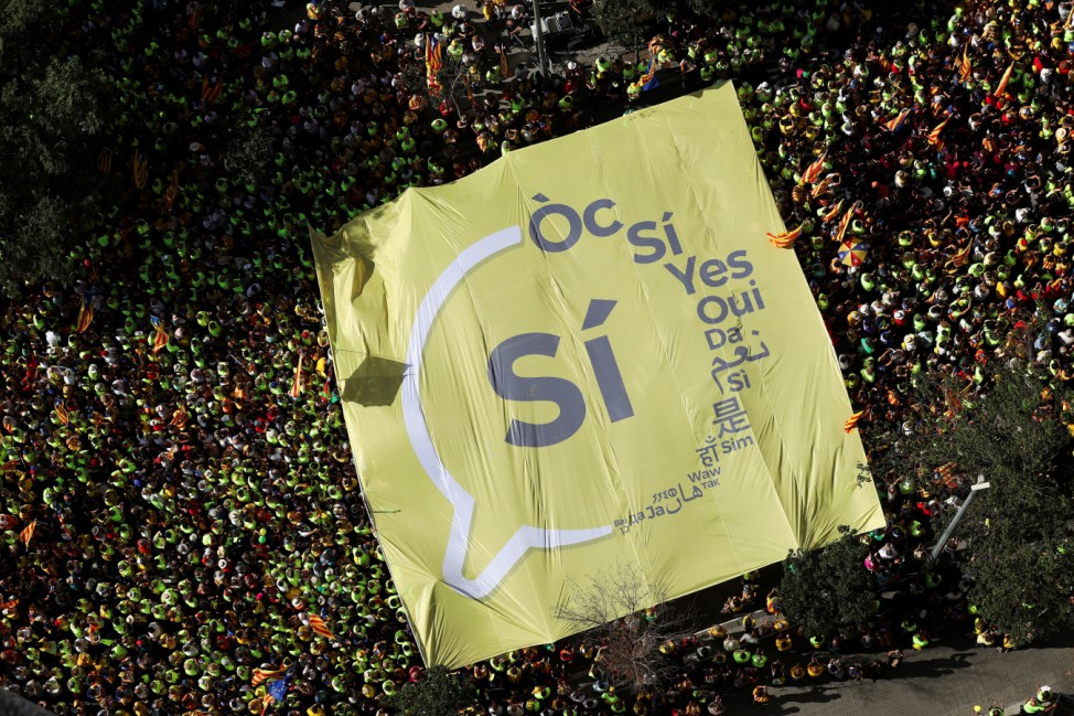 A giant 'Yes' banner is carried as thousands of people gather for a rally on Catalonia's national day 'La Diada' in Barcelona