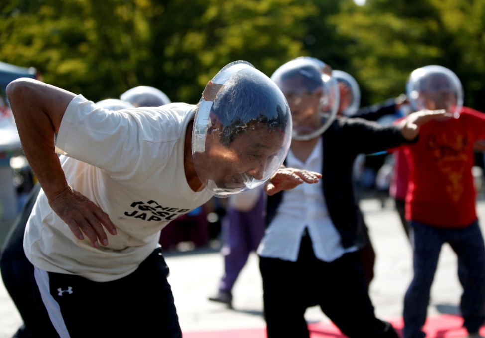 Masayoshi Koiso, a 69-year-old homeless man and a member of Newcomer 'H' Sokerissa! - a group of current and former homeless dancers, performs at a park in Tokyo