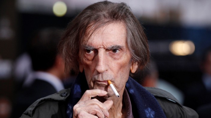 FILE PHOTO: Actor Stanton smokes a cigarette as he poses at the world premiere of the film 'Marvel's The Avengers' in Hollywood, California