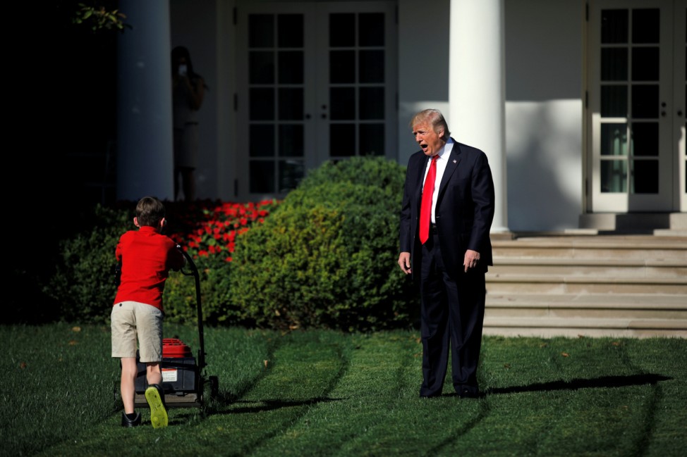 U.S. President Donald Trump welcomes 11-years-old Frank Giaccio as he cuts the Rose Garden grass at the White House in Washington