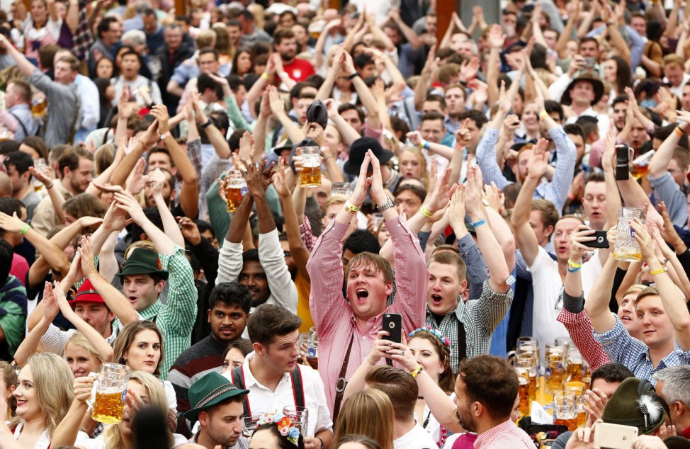 Visitors cheer during the opening day of the 184th Oktoberfest in Munich