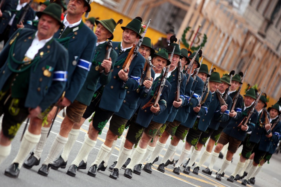 People dressed in traditional Bavarian clothes take part in Oktoberfest parade in Munich