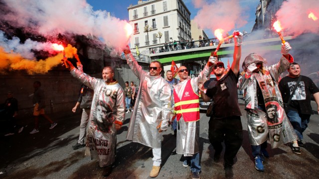ArcelorMittal steel workers dressed in protective work suits attend a national strike and protest against the government's labour reforms in Marseille