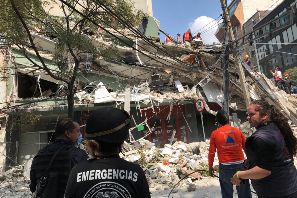 People work at the site of a collapsed building after an earthquake hit in Mexico City, Mexico