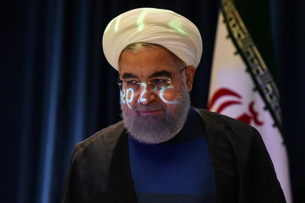 A video projection is seen on the face of Iran's President Hassan Rouhani as he arrives for a news conference during the United Nations General Assembly in New York City