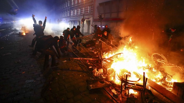 Barricades burn as protesters clash with riot police during the protests at the G20 summit in Hamburg