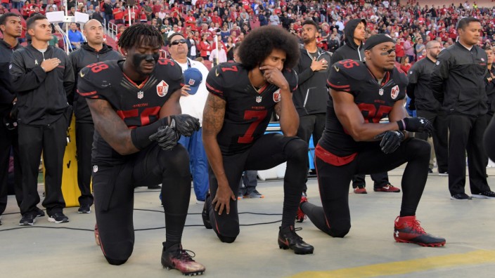 San Francisco 49ers outside linebacker Harold, quarterback Kaepernick and free safety Reid kneel in protest during the playing of the national anthem before a NFL game against the Arizona Cardinals in Santa Clara