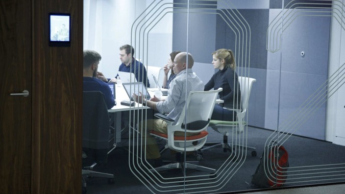 People hold a meeting in a room at the Jellyfish office space in London