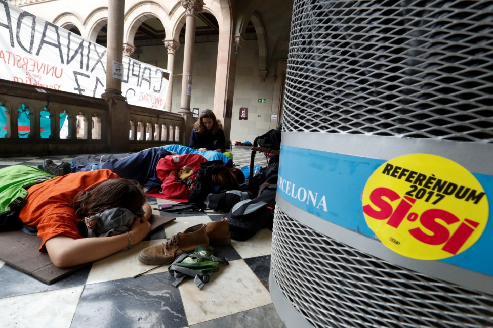 People sleep inside the University of Barcelona's historic building during a protest in favour of the banned October 1 independence referendum, in Barcelona