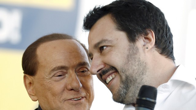 FILE PHOTO: Forza Italia party (PDL) leader Berlusconi talks with Northern League leader Salvini during a rally in Bologna