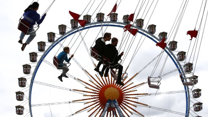 Visitors ride a carousel during the opening day of the 184th Oktoberfest in Munich