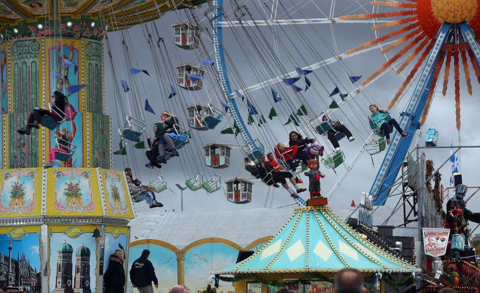 Visitors ride a swing ride during the last day of the 184th Oktoberfest in Munich