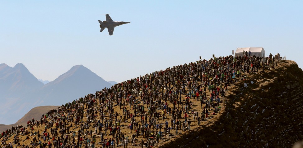 Swiss Air Force F/A18 Hornet fighter jet flies past spectators on the Axalp