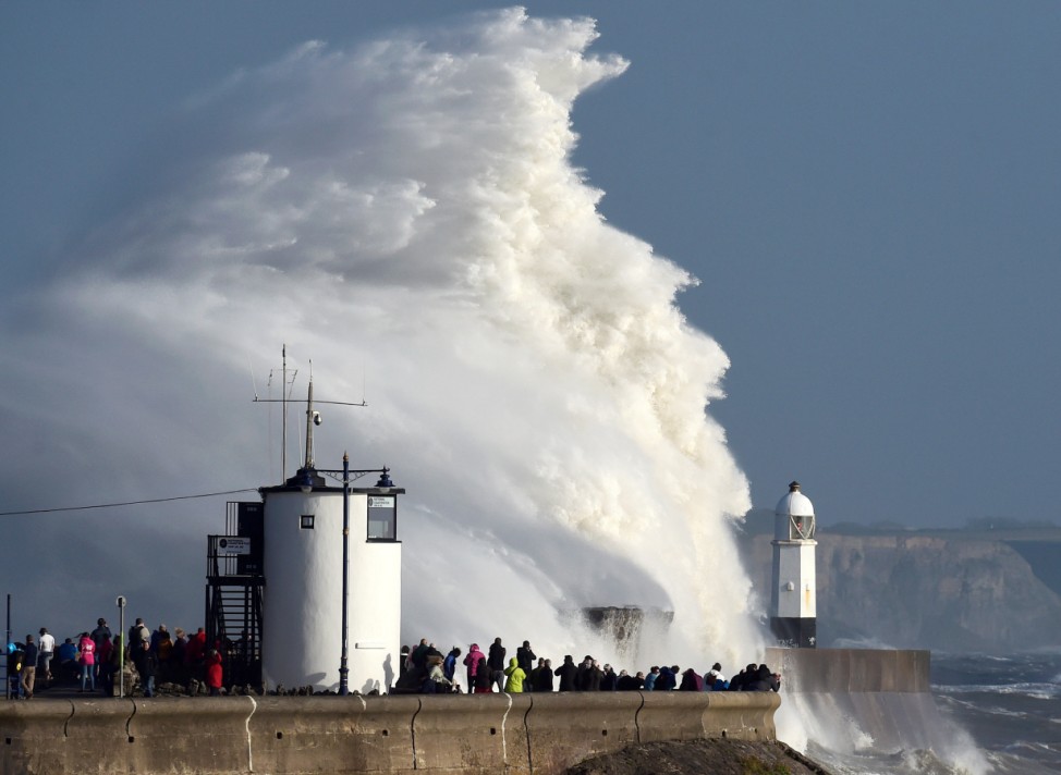 Waves crash over the lighthouse as storm Ophelia passes Porthcawl, Wales