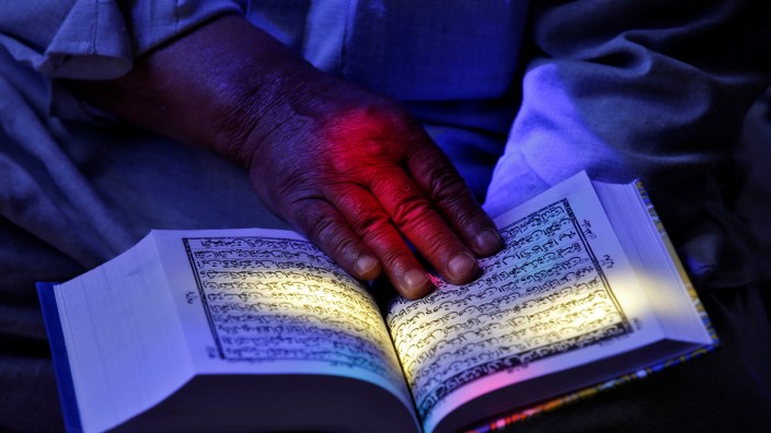 A man reads the Koran at the shrine of Sheikh Abdul Qadir Jeelani, a Sufi saint, during the Muslim fasting month of Ramadan in Srinagar
