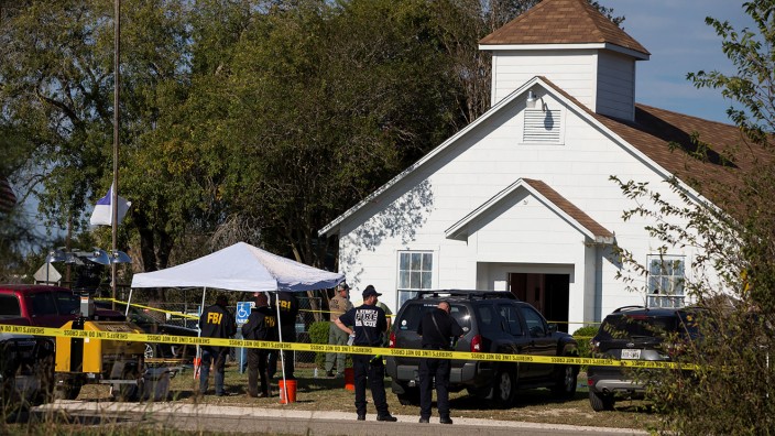 Law enforcement officials investigate a mass shooting at the First Baptist Church in Sutherland Springs