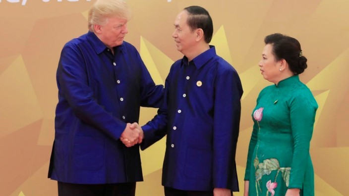 U.S. President Donald Trump is welcomed by his Vietnamese counterpart Tran Dai Quang and his wife Nguyen Thi Hien for the gala dinner of the Asia-Pacific Economic Cooperation Summit in Danang