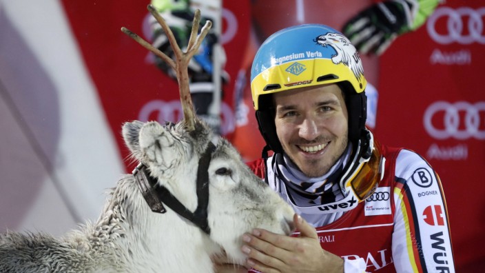 Felix Neureuther GER poses with a reindeer at the prize giving ceremony after Alpine Skiing FIS Wo