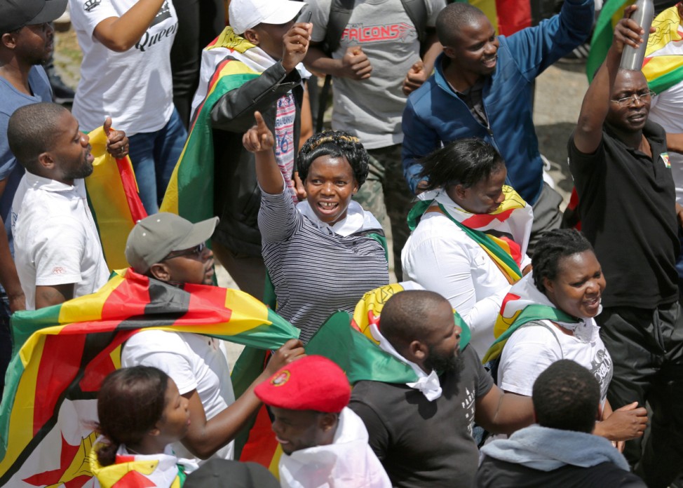 Protesters march calling for Zimbabwean President Robert Mugabe to step down in Cape Town