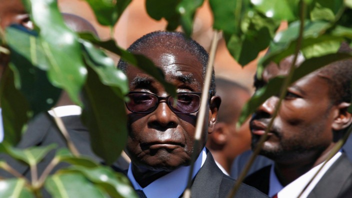 FILE PHOTO -  File photo of Zimbabwe's President Robert Mugabe arriving for the burial of ZANU (PF) member Edson Ncube in Harare