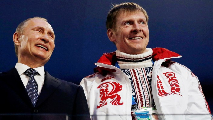 FILE PHOTO: Russian President Putin laughs with Russia's gold medallist bobsleigh athlete Zubkov during the closing ceremony for the 2014 Sochi Winter Olympics