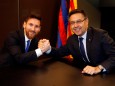 Barcelona's Argentine superstar Lionel Messi poses with FC Barcelona president Josep Maria Bartomeu during the signing of his new contract in Barcelona