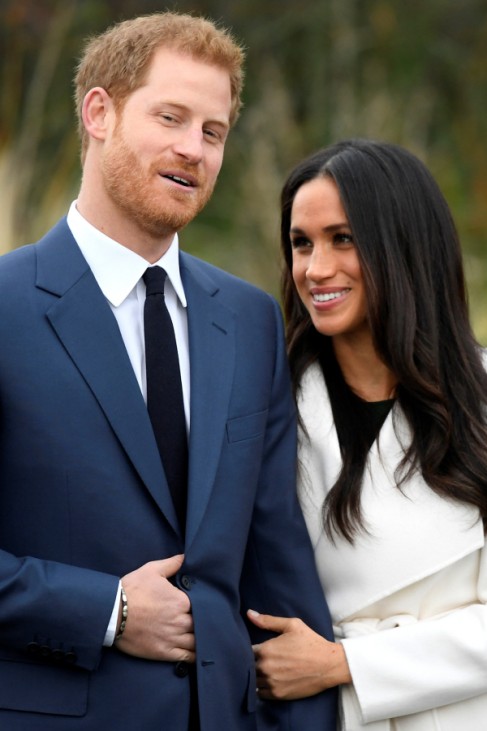 Britain's Prince Harry poses with Meghan Markle in the Sunken Garden of Kensington Palace, London