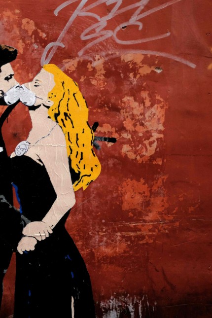 Nachhaltige Geldanlage: Kuss mit Mundschutz: Der Künstler Tvboy, der sich bei diesem Graffito einer Filmszene aus „La Dolce Vita“ („Das süße Leben“) mit Marcello Mastroianni and Anita Ekberg bediente, macht mit der Greenpeace-Aktion in Rom auf die Folgen der Luftverschmutzung aufmerksam.