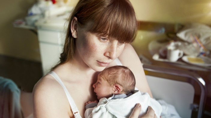 Mother holding her newborn baby in hospital room model released Symbolfoto PUBLICATIONxINxGERxSUIxAU