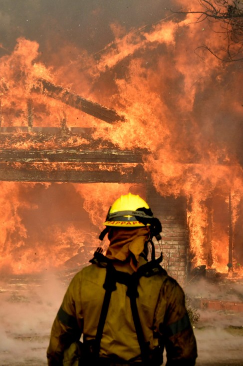Firefighters battle to save one of many homes burning in an early-morning Creek Fire that broke out in the Kagel Canyon area in the San Fernando Valley north of Los Angeles
