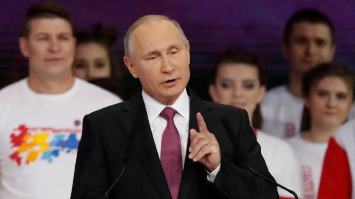 Russian President Putin addresses the audience at the congress of volunteers in Moscow