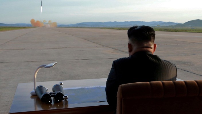 FILE PHOTO: North Korean leader Kim Jong Un watches the launch of a Hwasong-12 missile in this undated photo released by North Korea's KCNA