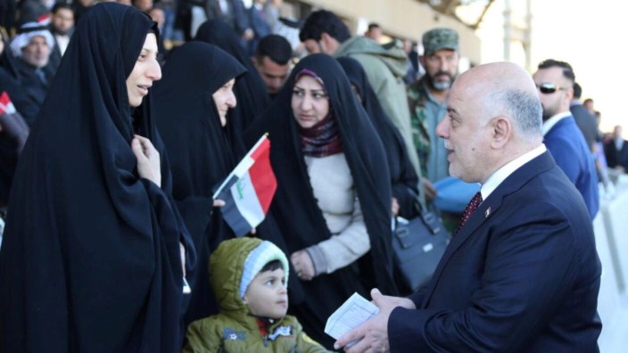 Iraqi Prime Minister Haider al-Abadi greets people during an Iraqi military parade in Baghdad