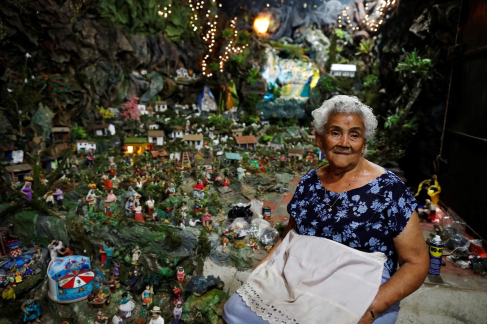 Petrona Chavez poses with her nativity scene with more than 2000 figurines in Nahuizalco