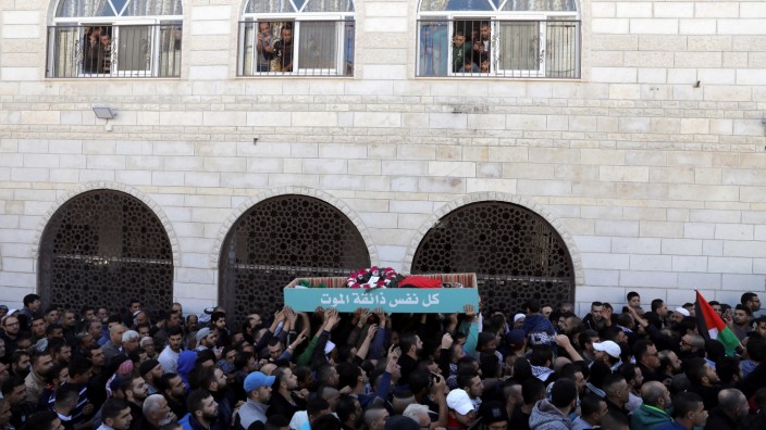 Palestinians carry the body of Bassel Mustafa Ibrahim during his funeral in the village of Anata, on the edge of Jerusalem