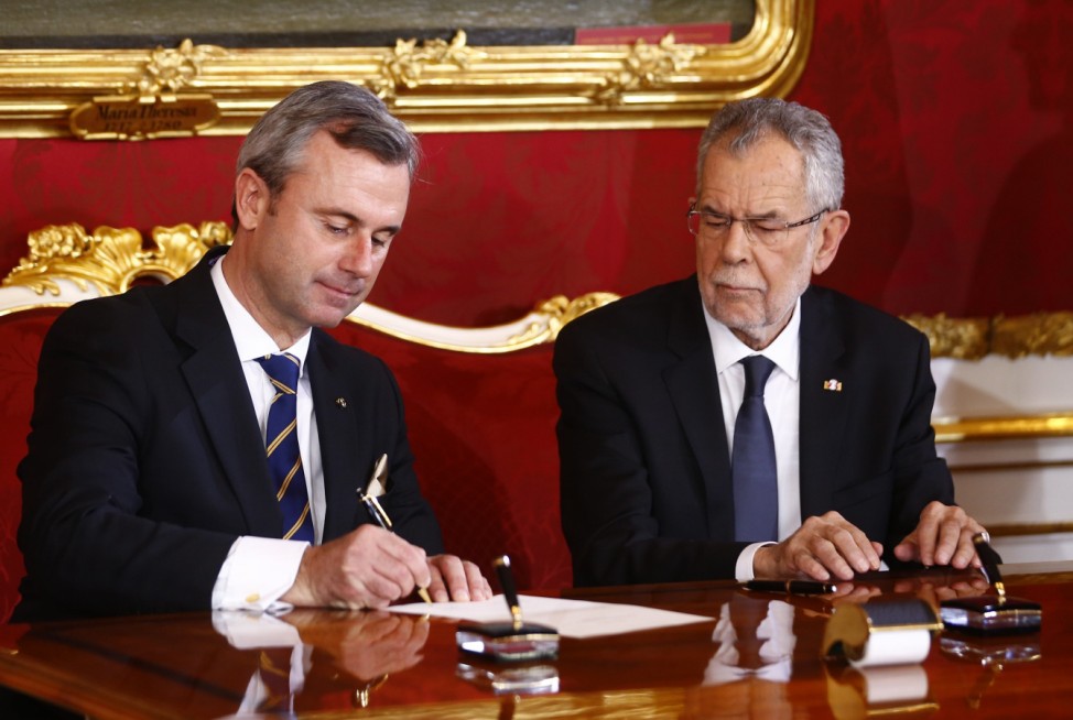 Austrian president van der Bellen and new  infrastructure minister Norbert Hofer sign contracts during the swearing-in ceremony of the new government in Vienna