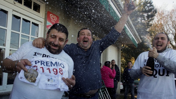 People, who bought winning tickets of the biggest prize of Spain's Christmas Lottery 'El Gordo' (The Fat One), celebrate in Vilalba